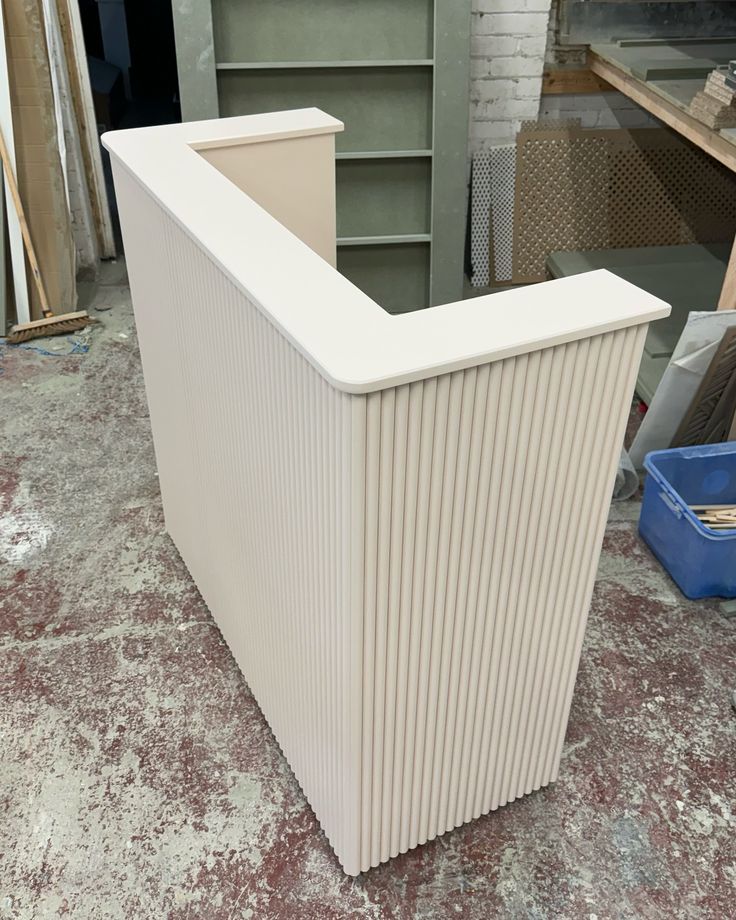 Cream fluted L-shaped reception desk