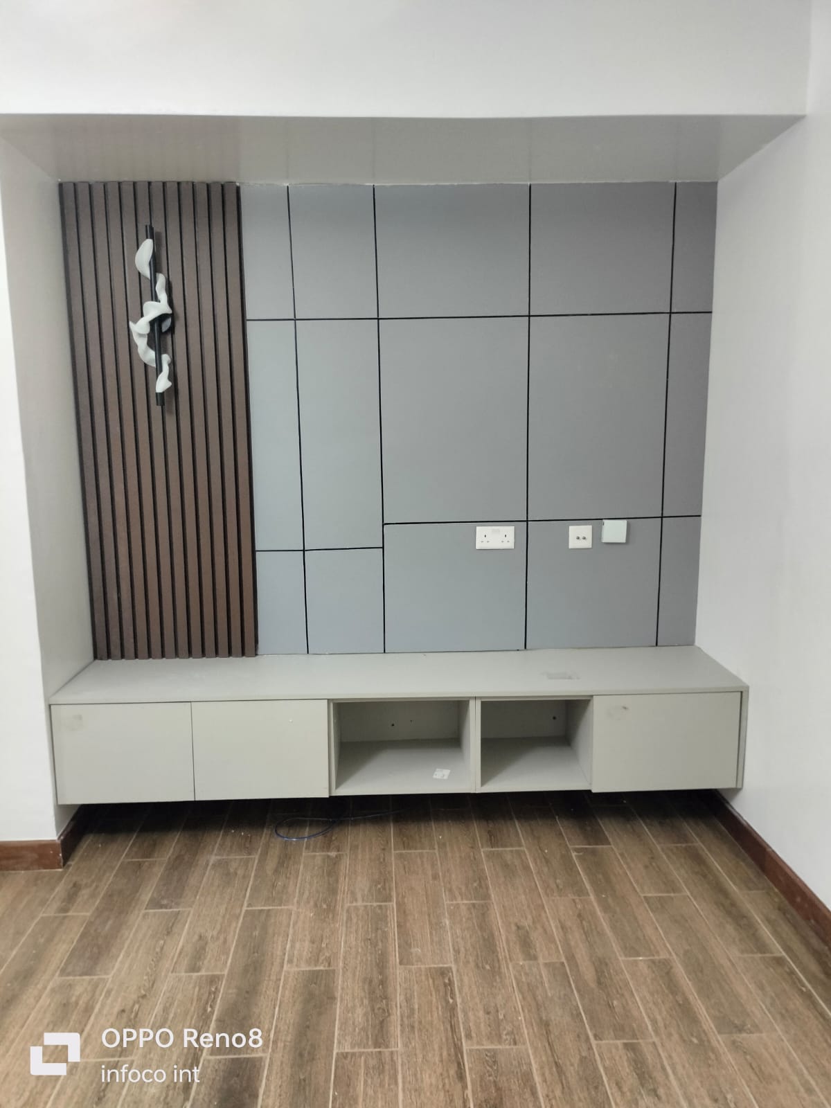 Grey panelled TV feature wall with floating cabinetry